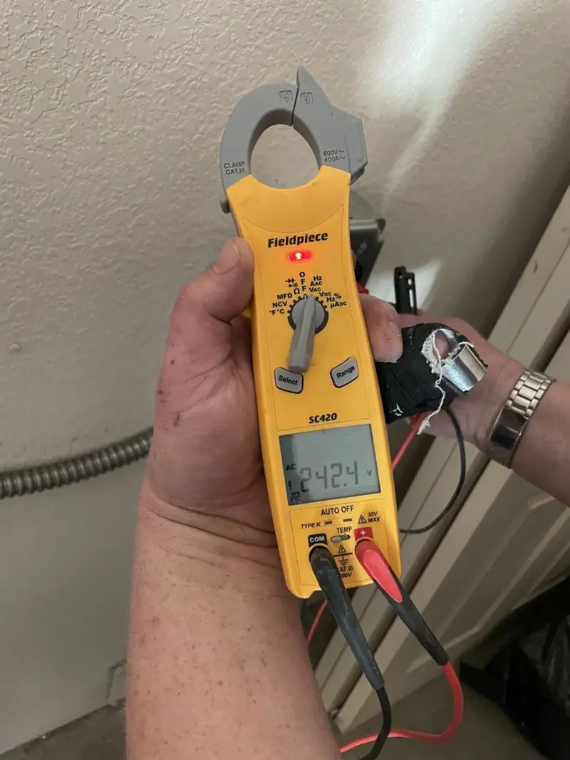 Voltage testing with clamp meter during Outlet Installation in Bloomfield Hills